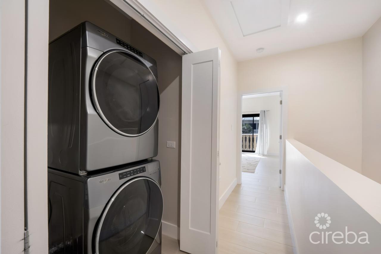 Purchased the end of 2022, the Whirlpool washer and dryer gives ample space for additional storage. Attic space above gives great space for seasonal decor storage and luggage.